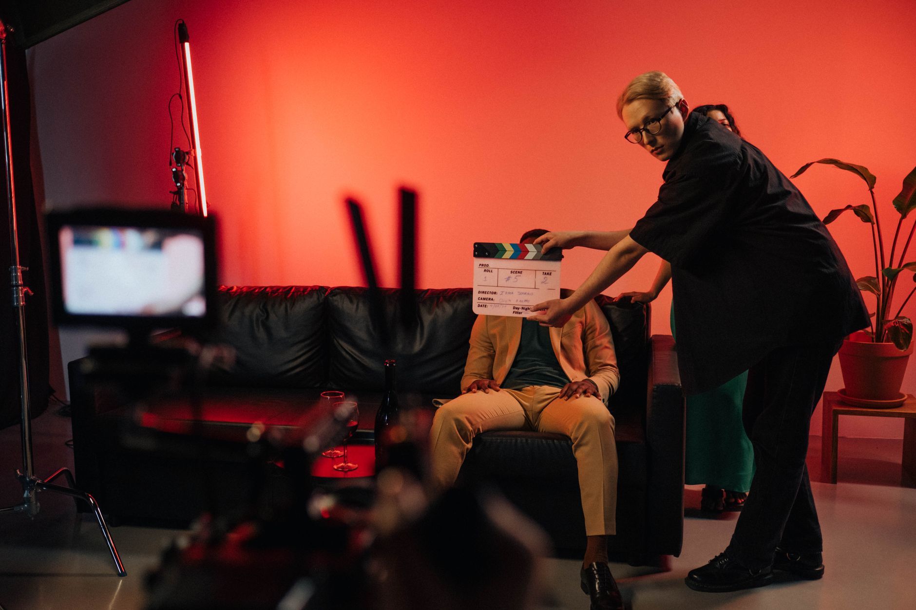 Film production crew working on a movie set with equipment visible in background