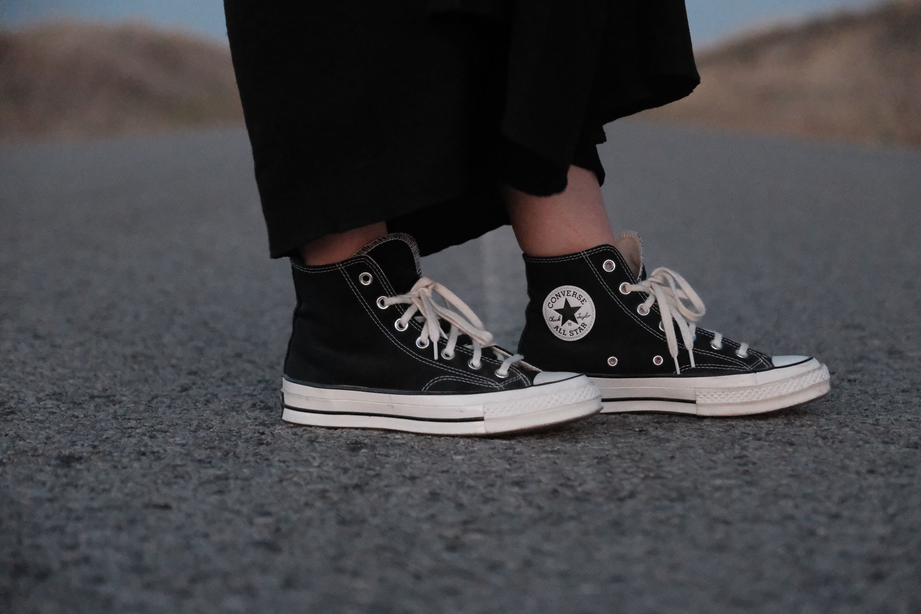 Styled sneakers with elevated casual outfit including denim and tote bag
