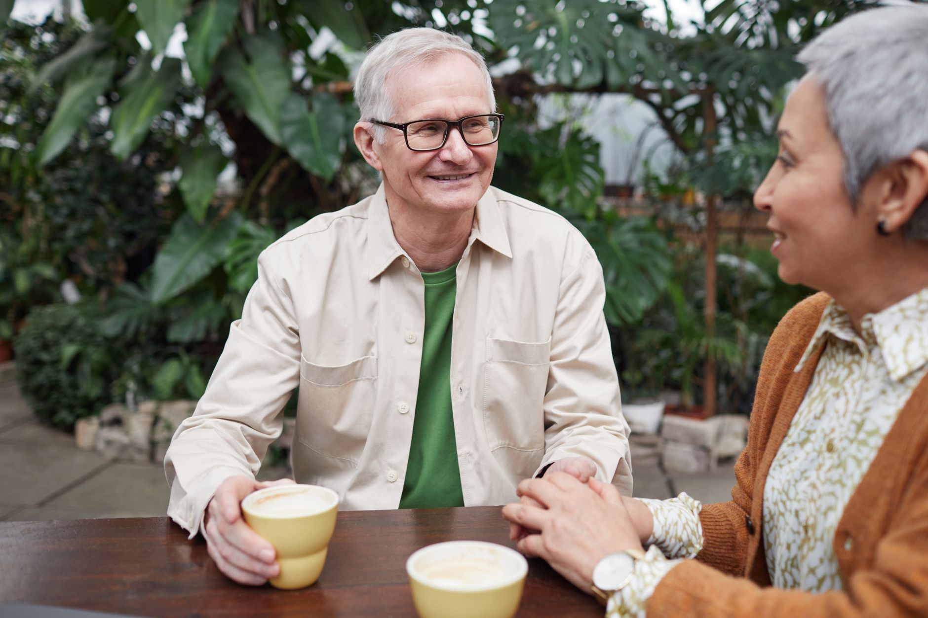 Two people having a serious conversation over coffee at a cafe table