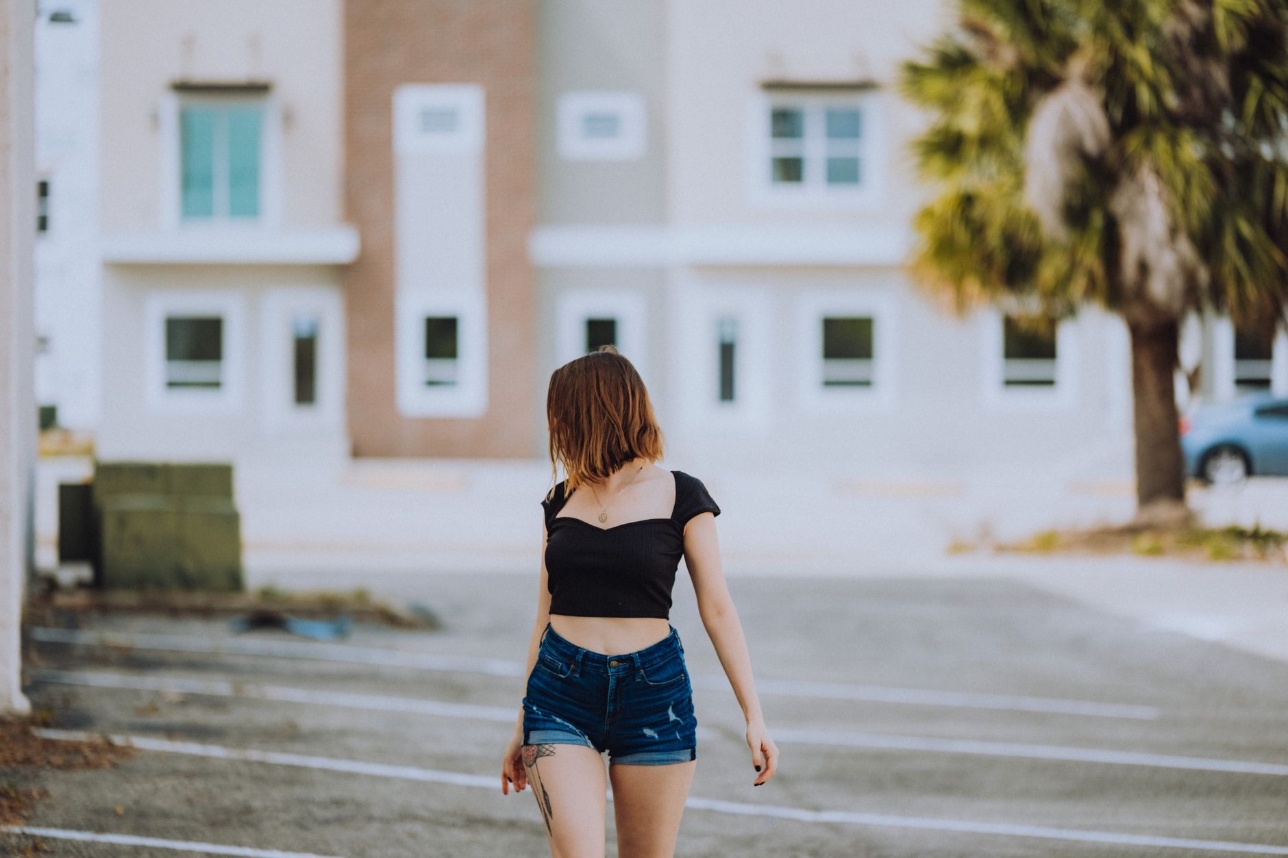 Close-up of wide-leg denim shorts styled with summer accessories