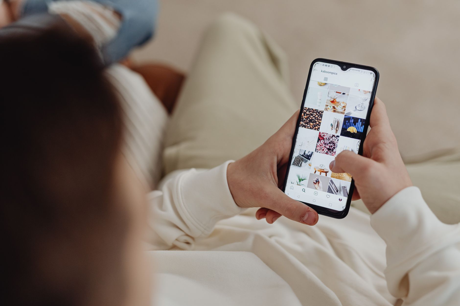 Person scrolling through social media on a smartphone at night