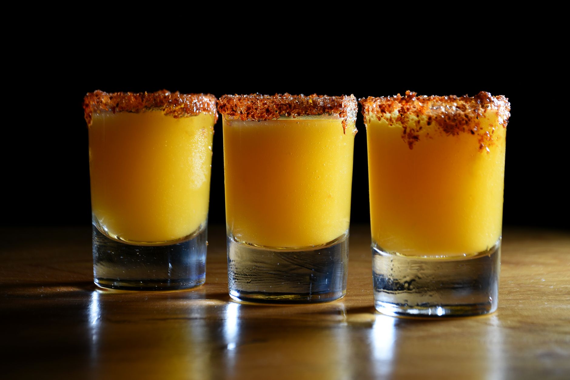 Tequila-based cocktails on ice at an outdoor summer gathering