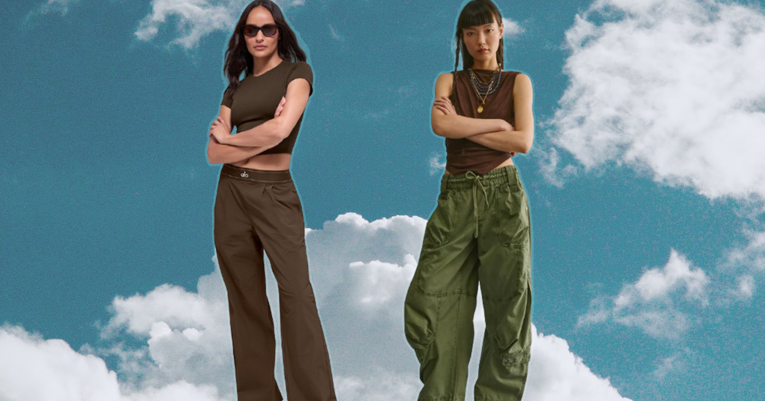 The Travel Pants Edit That Skips Leggings Entirely Woman in stylish wide-leg trousers walking through a bright airport terminal with a carry-on bag