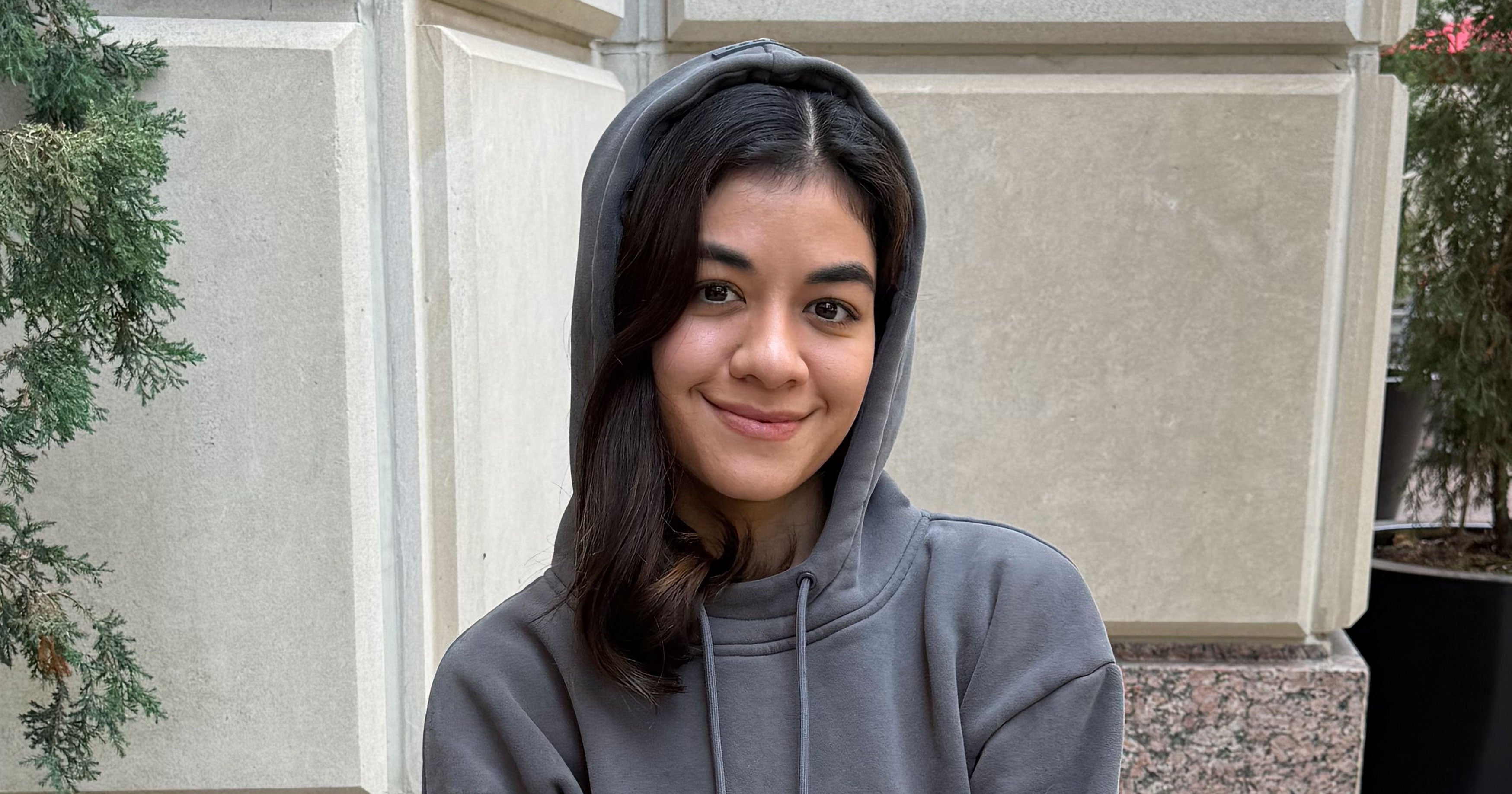 Person wearing a grey hoodie in a relaxed travel setting
