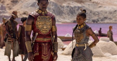 Tomi Adeyemi Wont Watch Her Own Film — Heres Why Open fantasy novel on a dark surface, pages illuminated with warm light