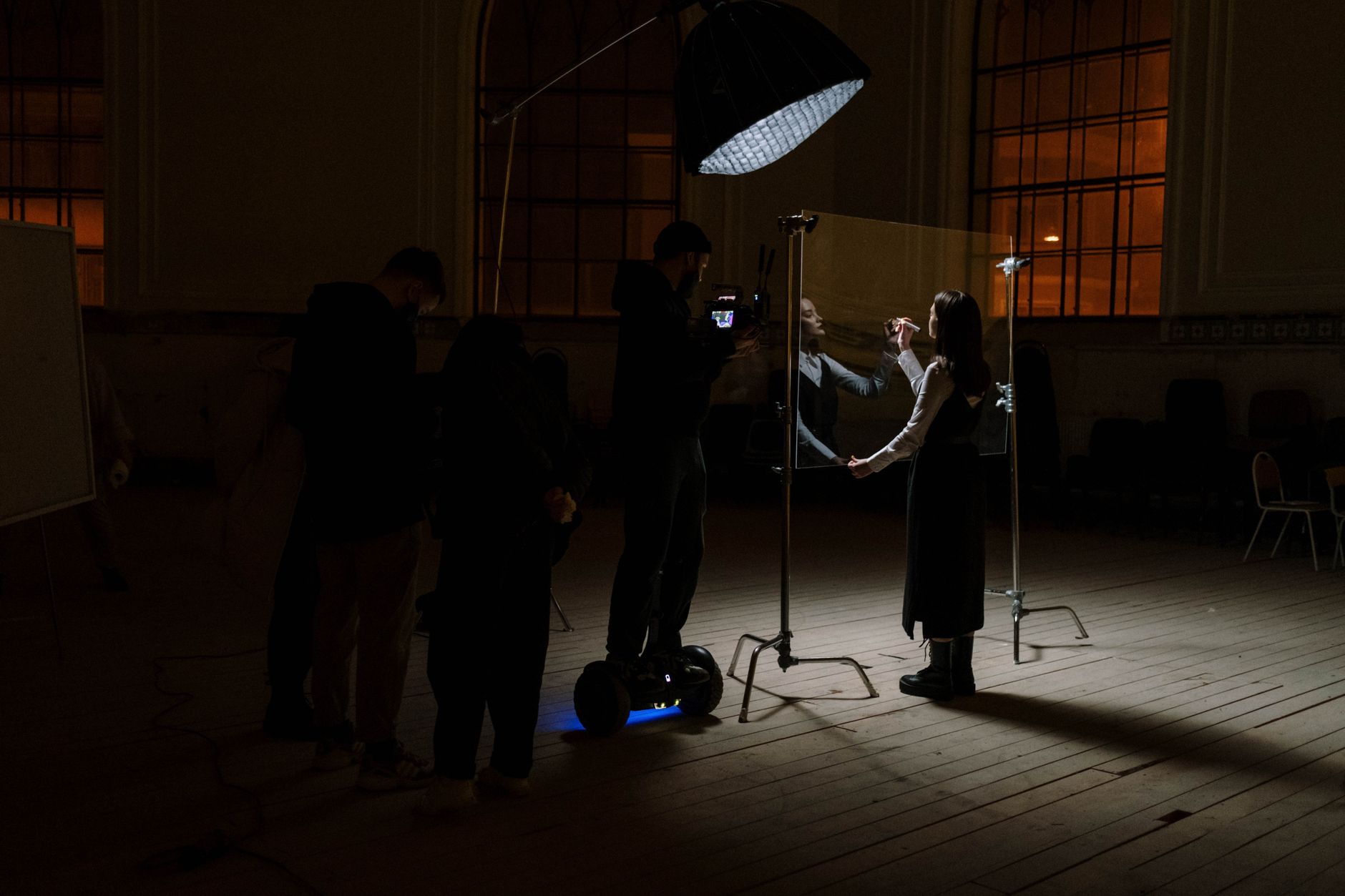 Single spotlight on an empty audition stage in a dark theater