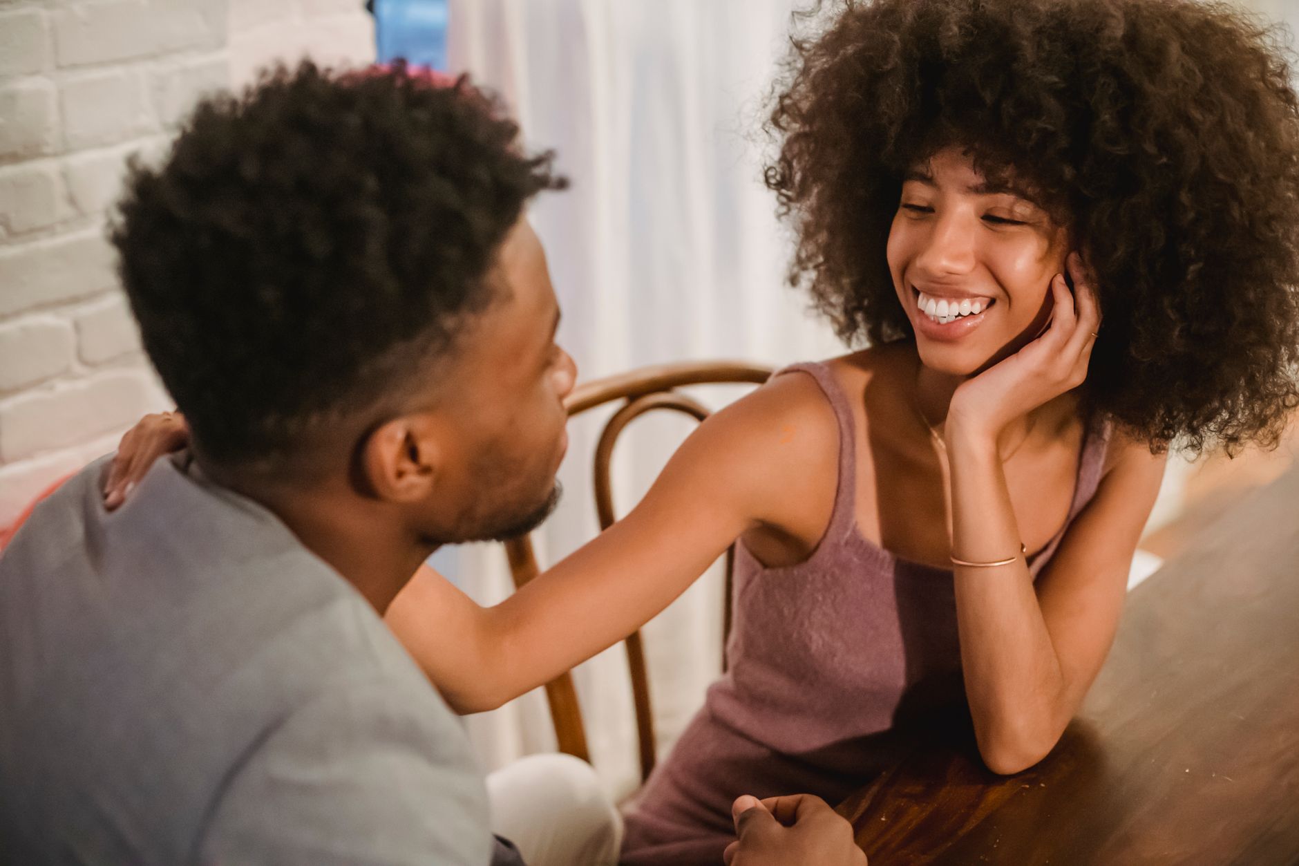 Couple in a quiet, close conversation representing emotional intimacy in a relationship