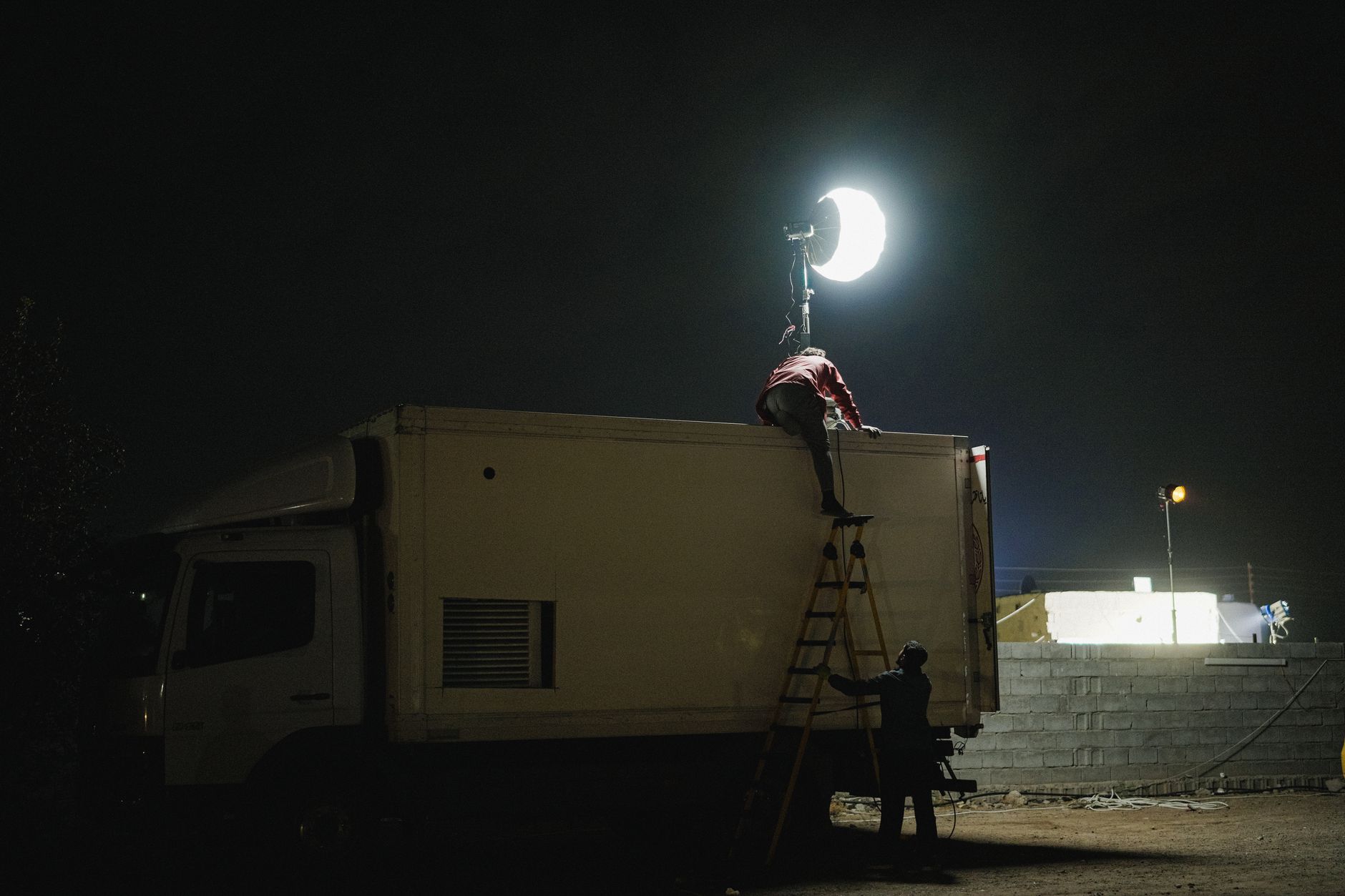 Dramatic film set with moody lighting suggesting an intimate scene in production