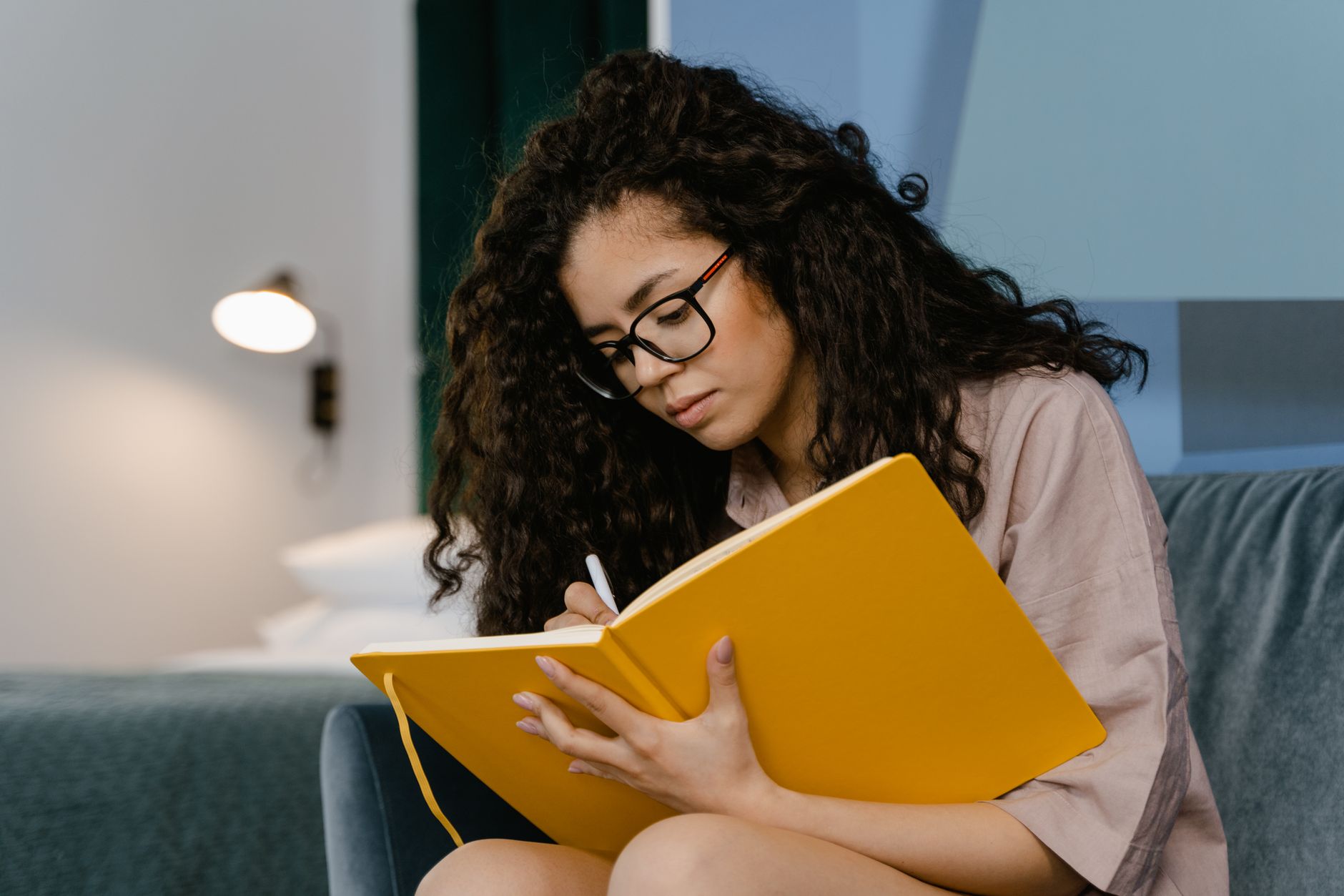 Woman writing in a journal during quiet moment of self-reflection