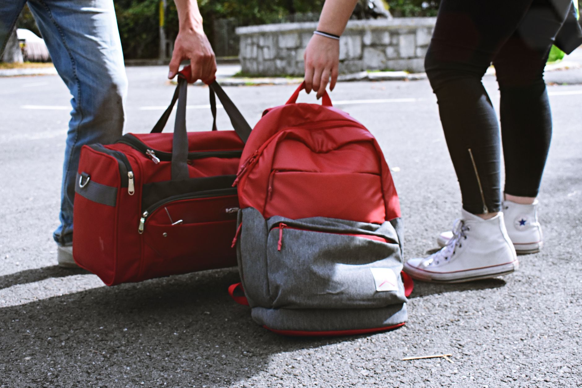 Open backpack being packed for travel with laptop and essentials