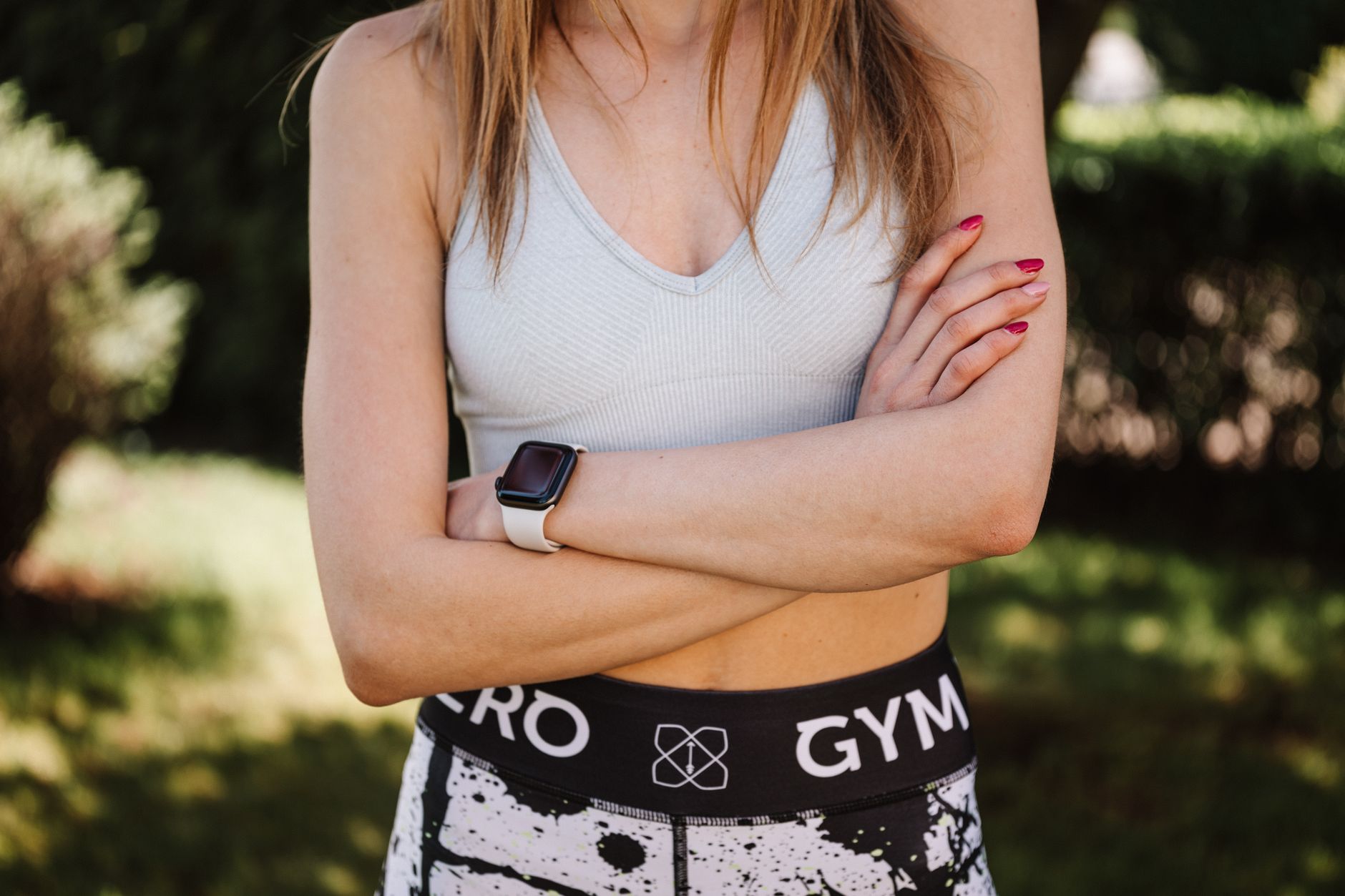 Flatlay of summer activewear pieces including tops and shorts on a light background