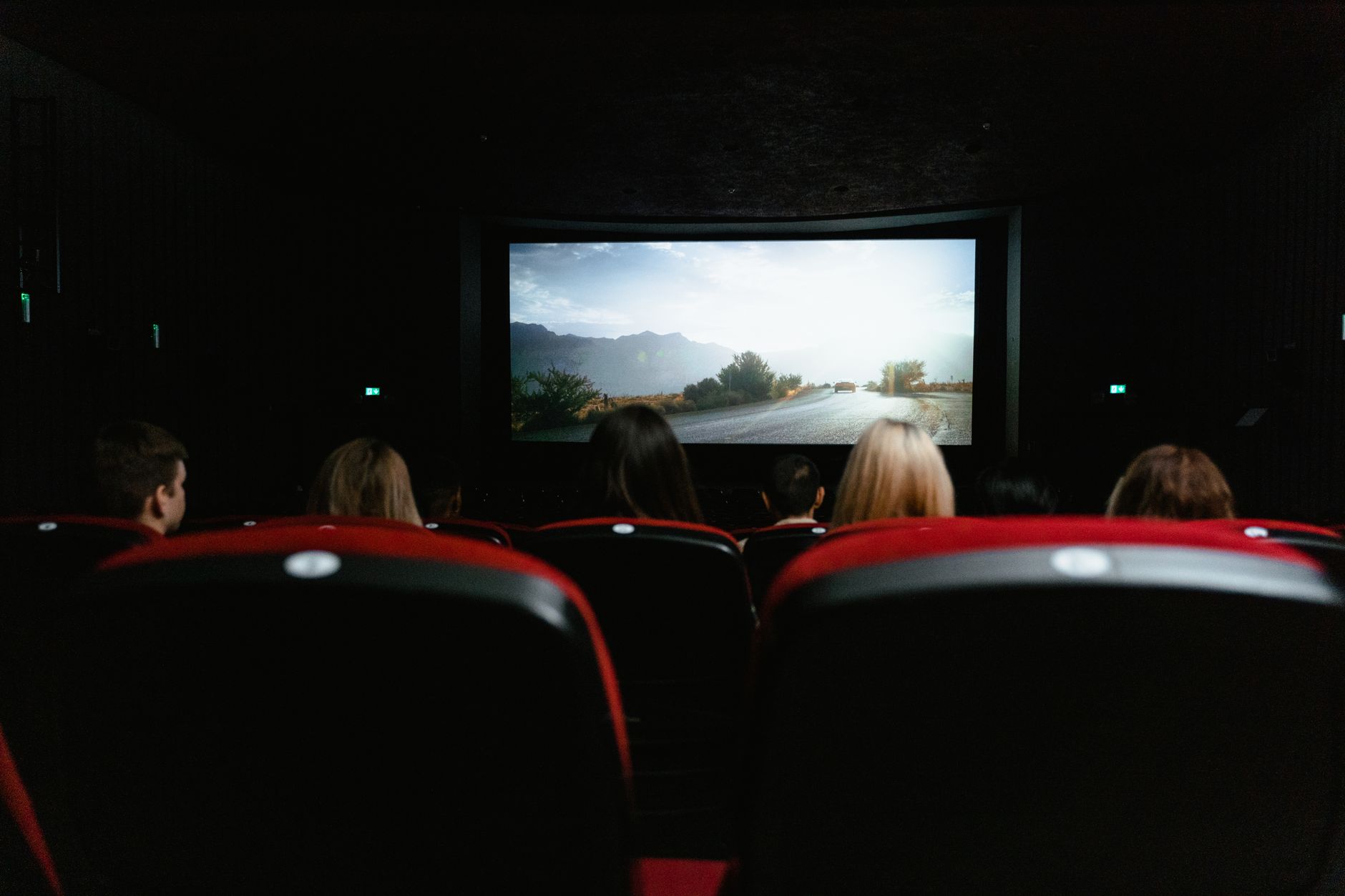 Audience watching a film in a darkened movie theater