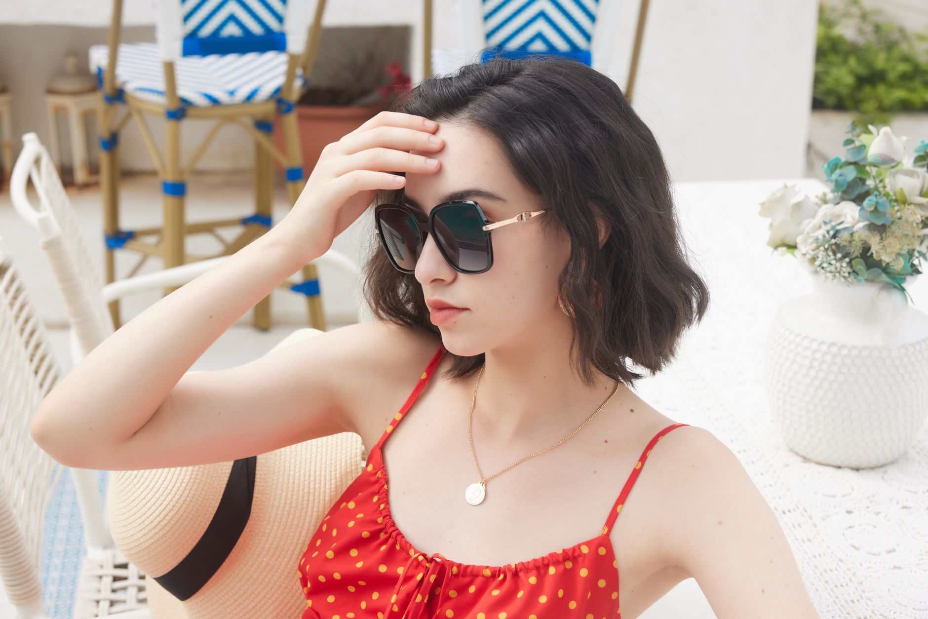 Close-up of a person wearing large statement sunglasses as part of a casual outfit