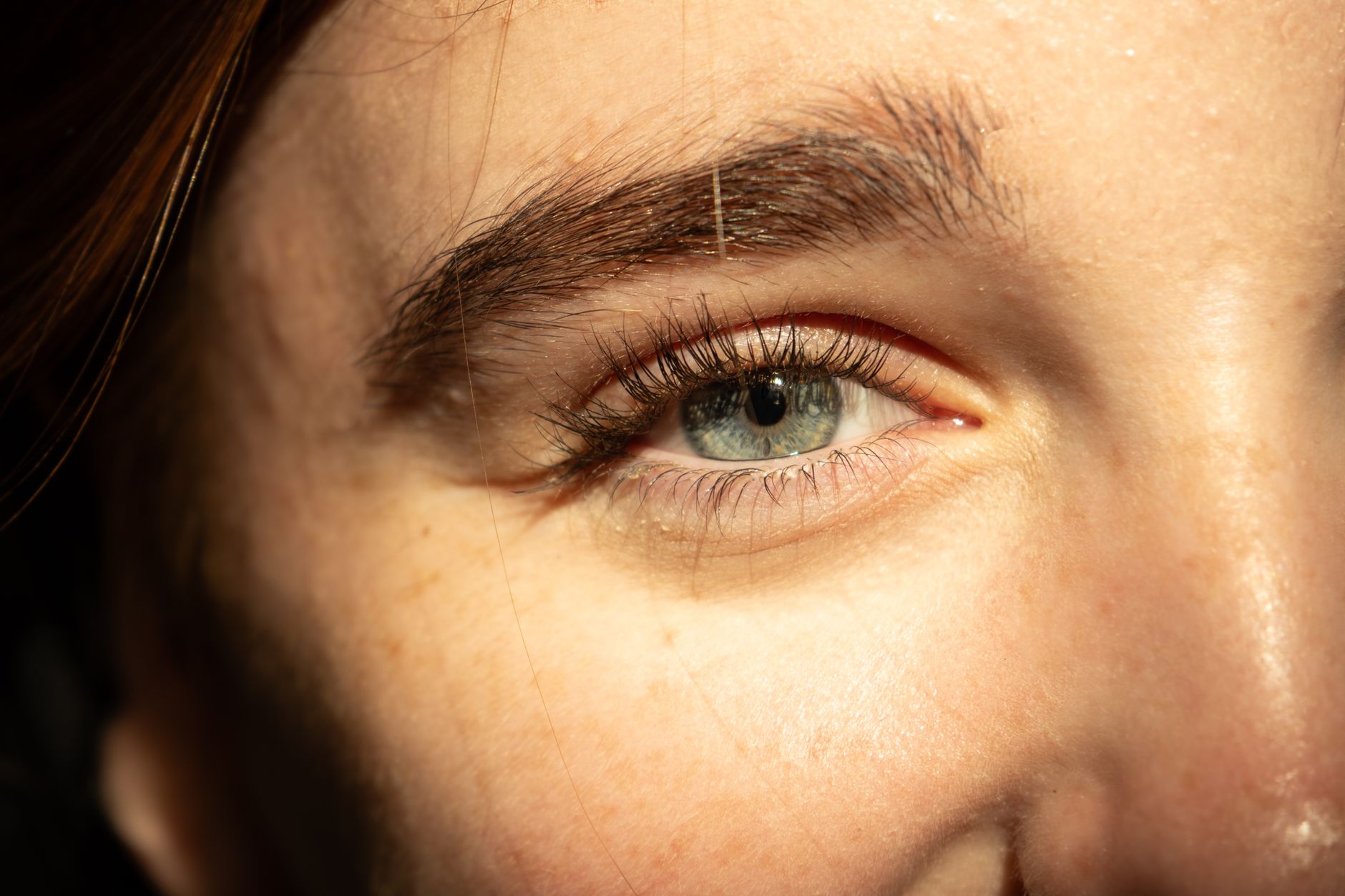 Close-up of a woman's eye area with healthy, hydrated skin