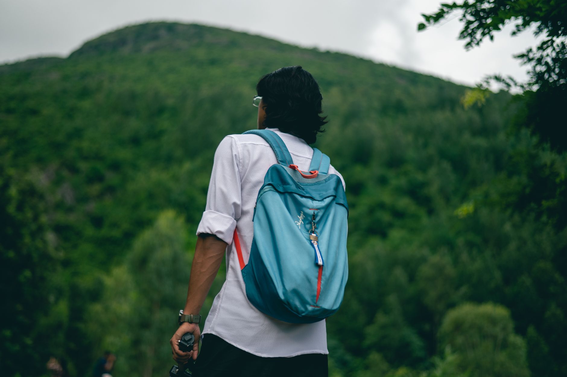 Person with a sport backpack on a hiking trail