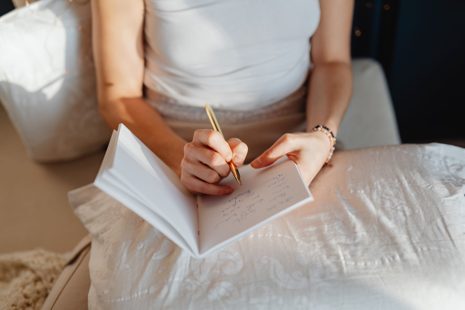 Woman writing in a journal during a quiet morning, reflecting on weekly horoscope insights