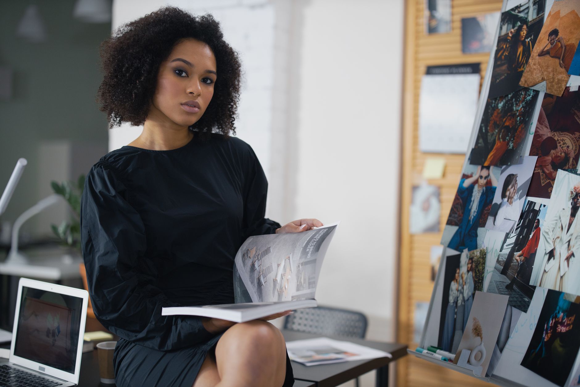 Fashion editor reviewing clothing and beauty products at a workspace