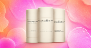 Close-up of premium deodorant and skincare products on a marble bathroom shelf