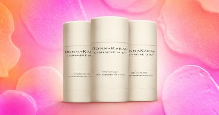 Close-up of premium deodorant and skincare products on a marble bathroom shelf
