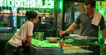 “I Would Move To Another Country”: Callum Turner & Monica Barbaro On One Night Only’s Absurd No Sex Mandate Premise New York City street at night with bright lights and pedestrians