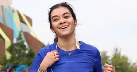 What a Beauty Editor Actually Wore for 13.1 Miles Woman in athletic gear running along an urban street on a sunny day