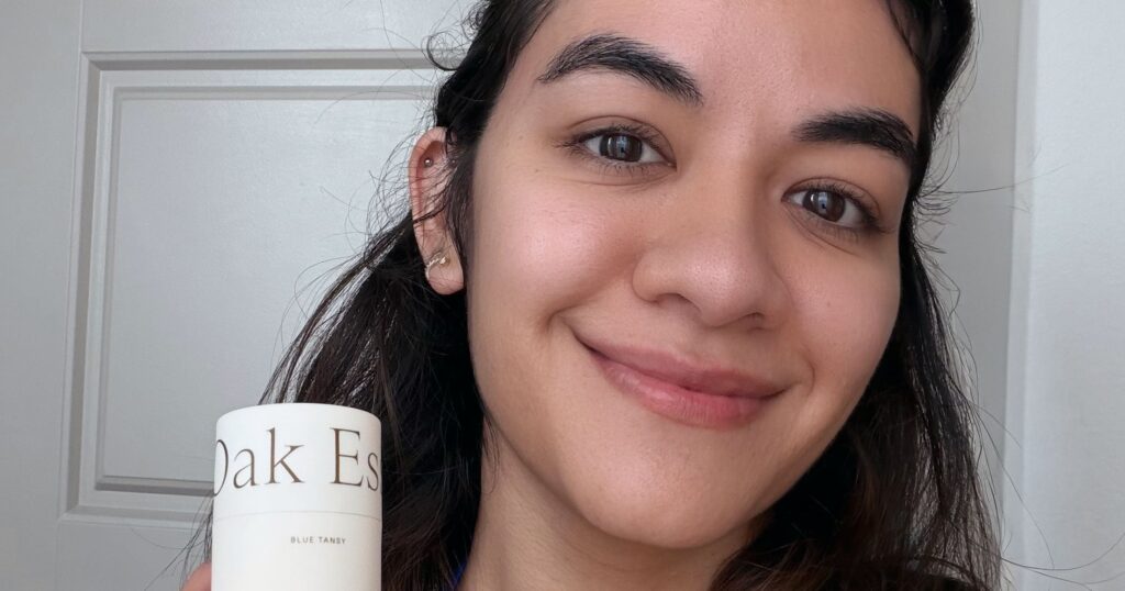 A natural deodorant stick resting on a minimal white surface