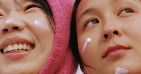 What Your Skin Actually Needs When the Temperature Drops Person applying moisturizer to face during a fall skincare routine