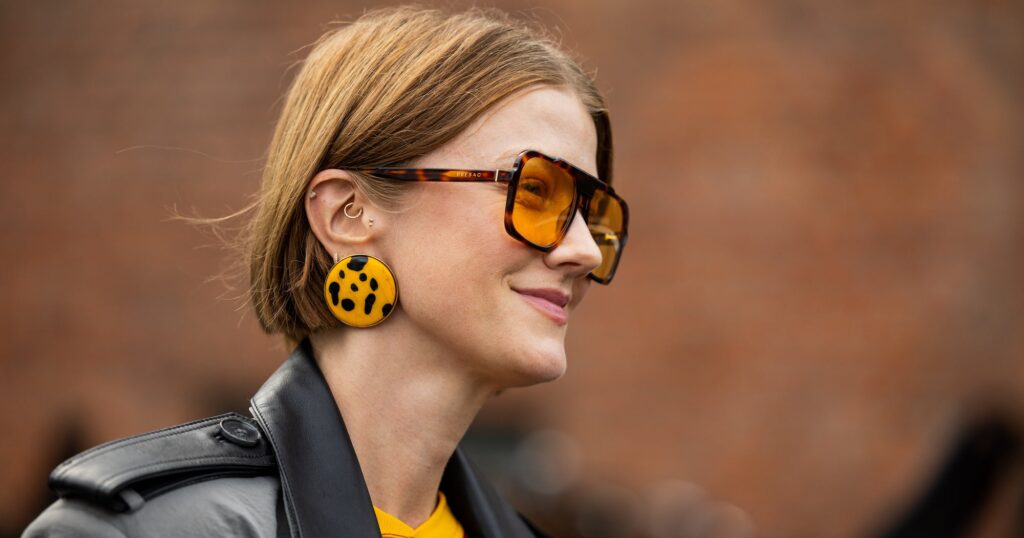 Copenhagen Fashion Week Spring 2027 Showcases the Biggest Haircut Trends A fashion week attendee with layered hair styled with volume and movement