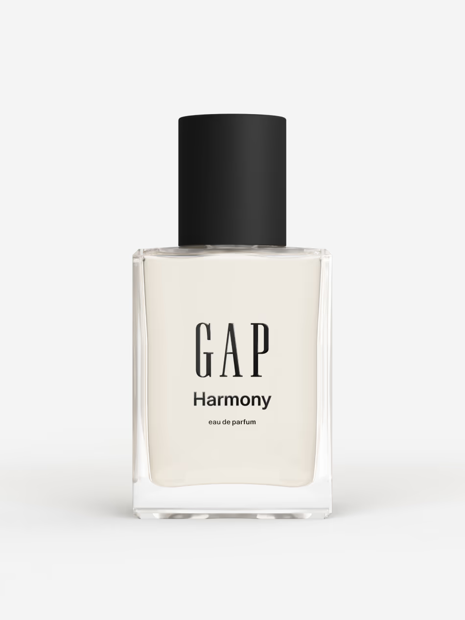 Person browsing fragrance bottles at a retail counter