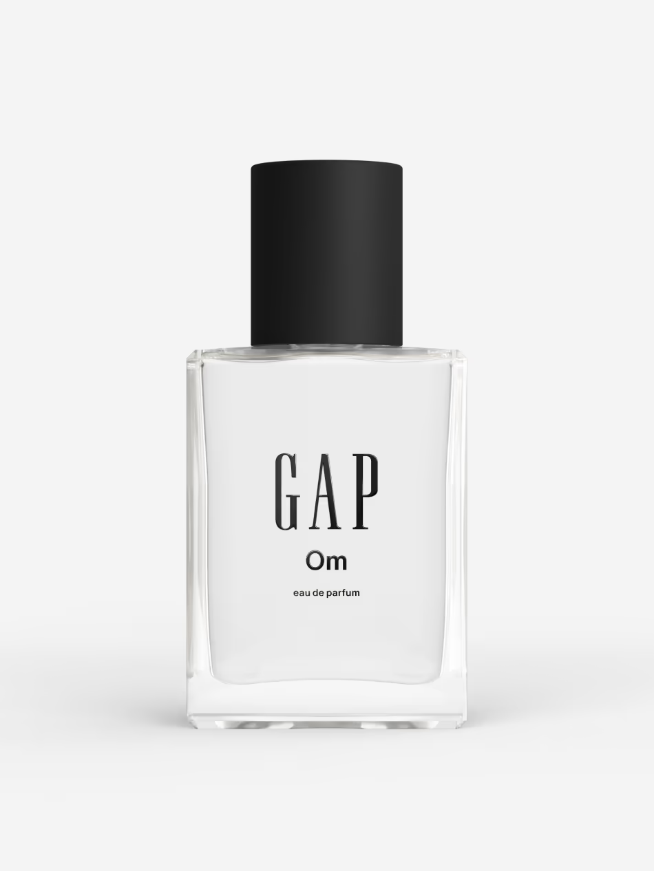 Woman spraying perfume on her wrist in natural light