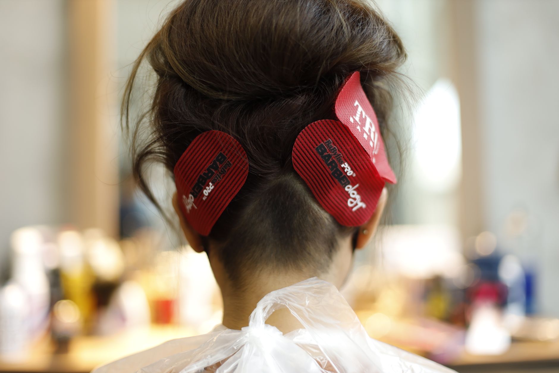 Close-up of round brush blow-drying a fringe section with low heat