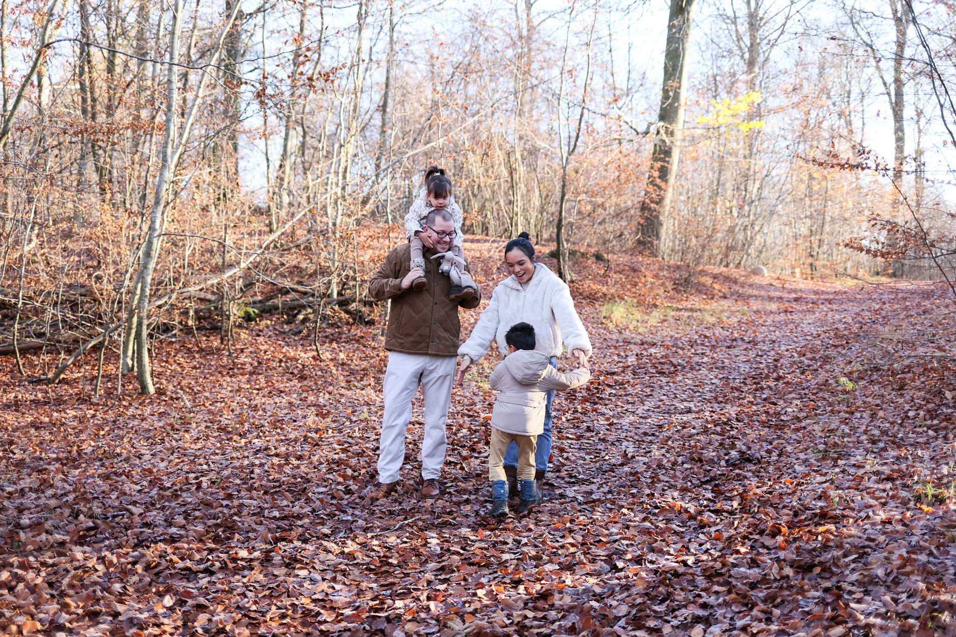 Mother and daughter in coordinated fall outfits outdoors