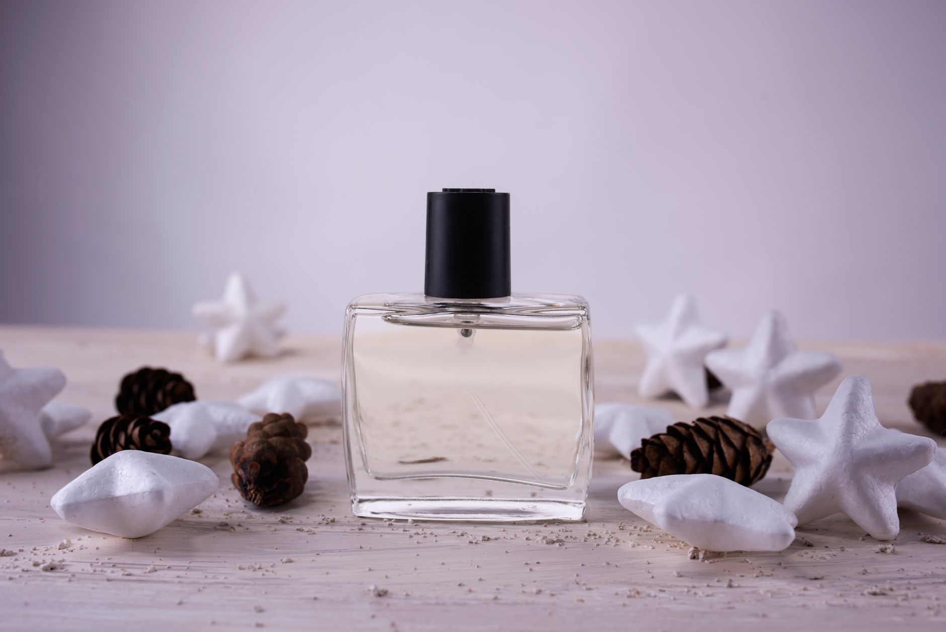 Person browsing fragrance bottles at a beauty counter