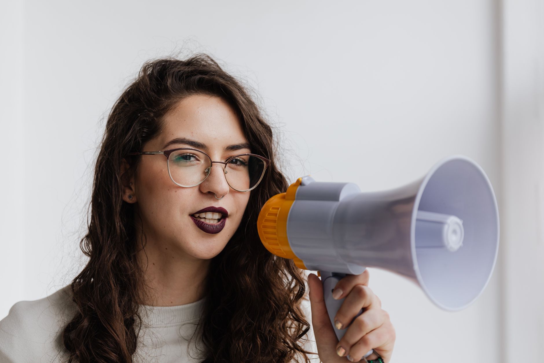 A confident woman speaking into a microphone, representing Lady London's presence as a rapper and public figure