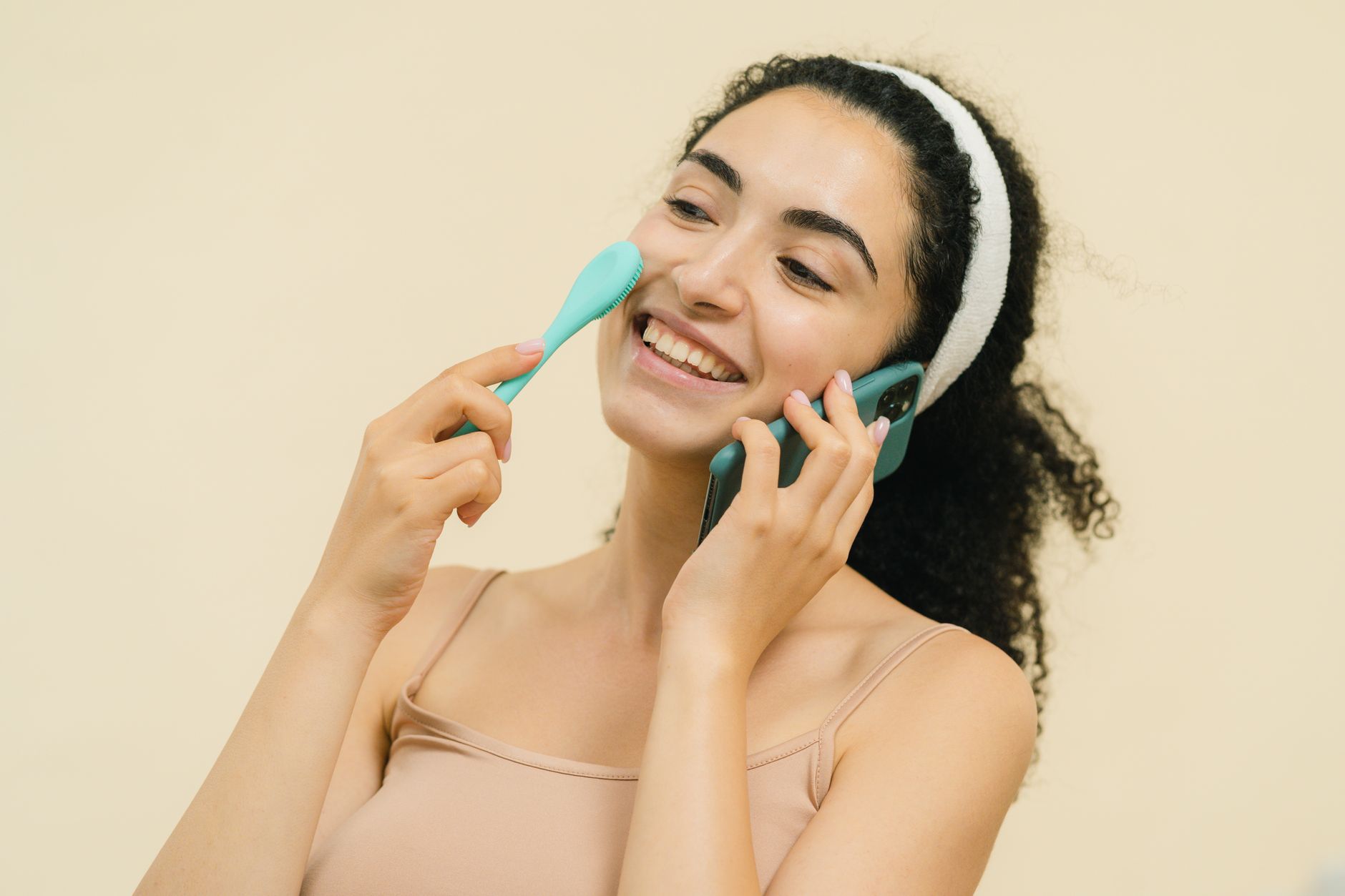 Woman using a wearable beauty device at home during skincare routine