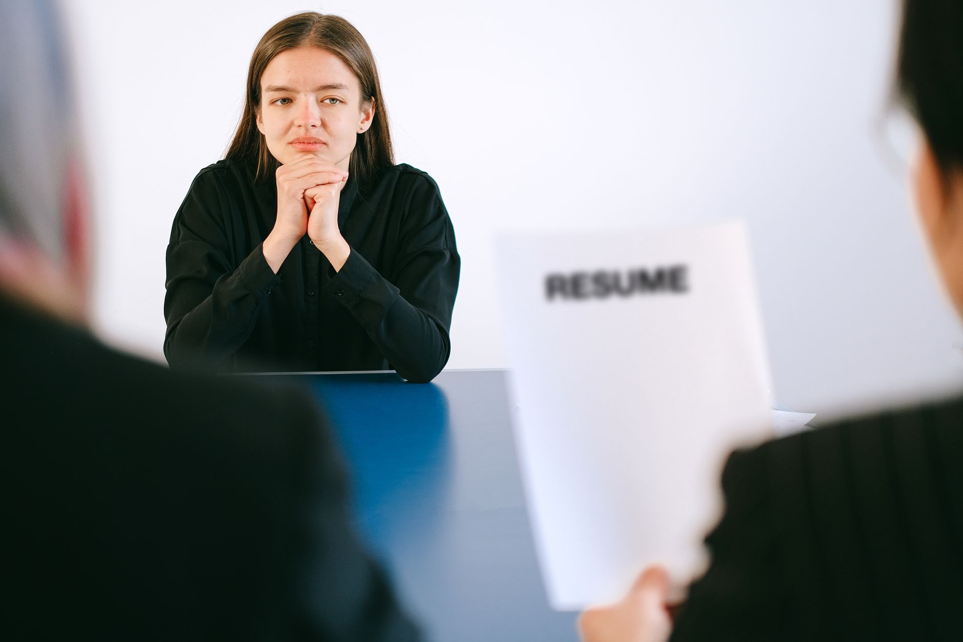 A young woman seated and composed before a formal on-camera interview