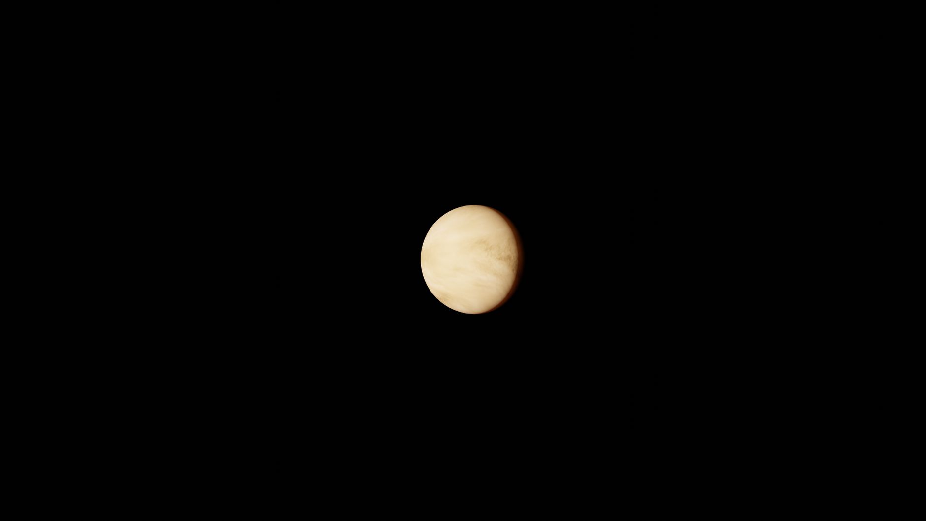 Bright planet Venus visible against a deep blue night sky with stars