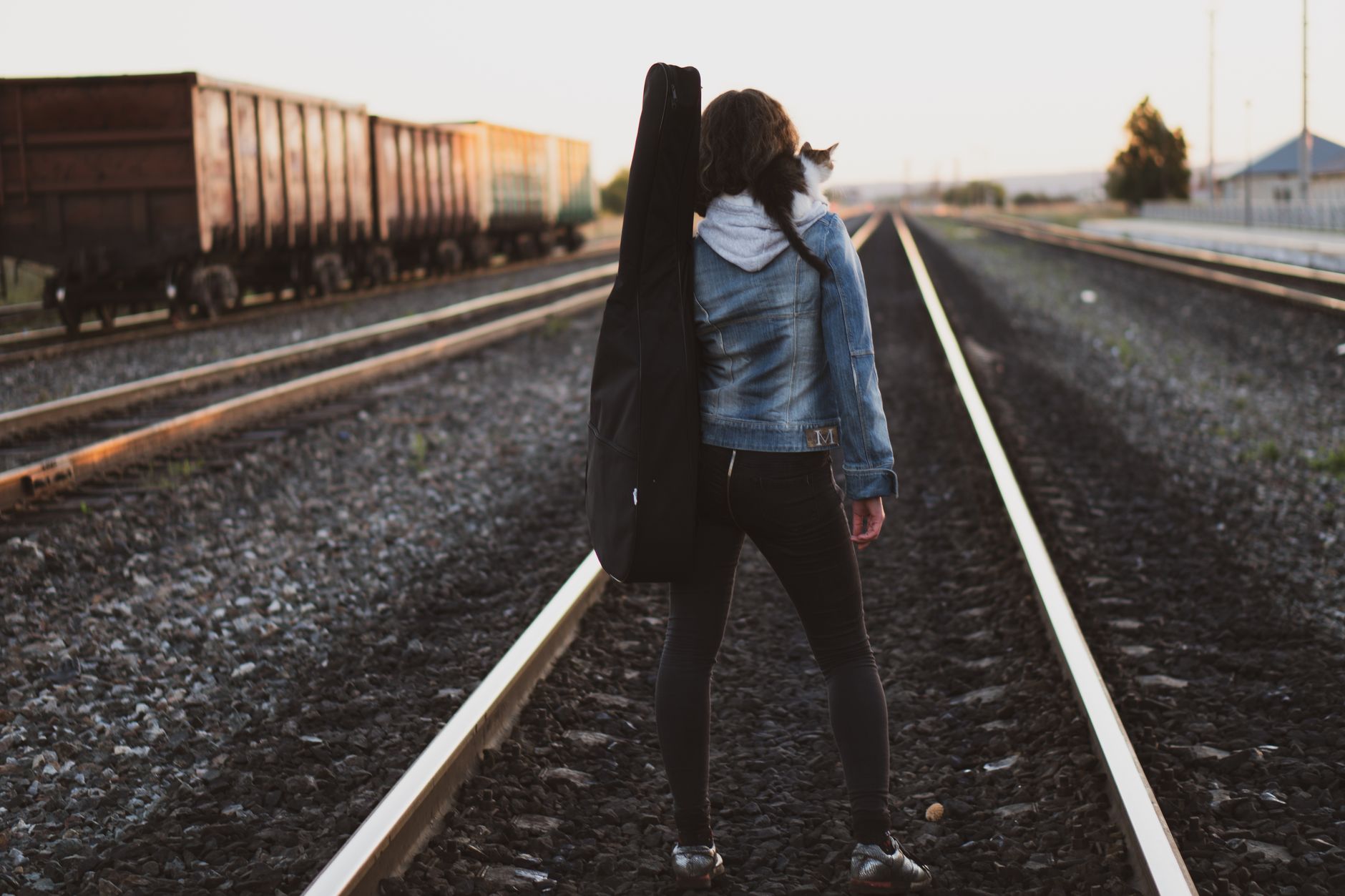 Young woman walking away from camera through an urban street, suggesting forward movement and a new direction