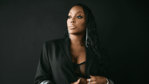 Porsha Williams Found 21 Fibroids and No Other Option Woman resting in a hospital bed, looking thoughtful and composed