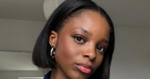 The Fall Haircuts Stylists Are Actually Cutting Right Now Woman with a sharp chin-length bob haircut in a salon setting