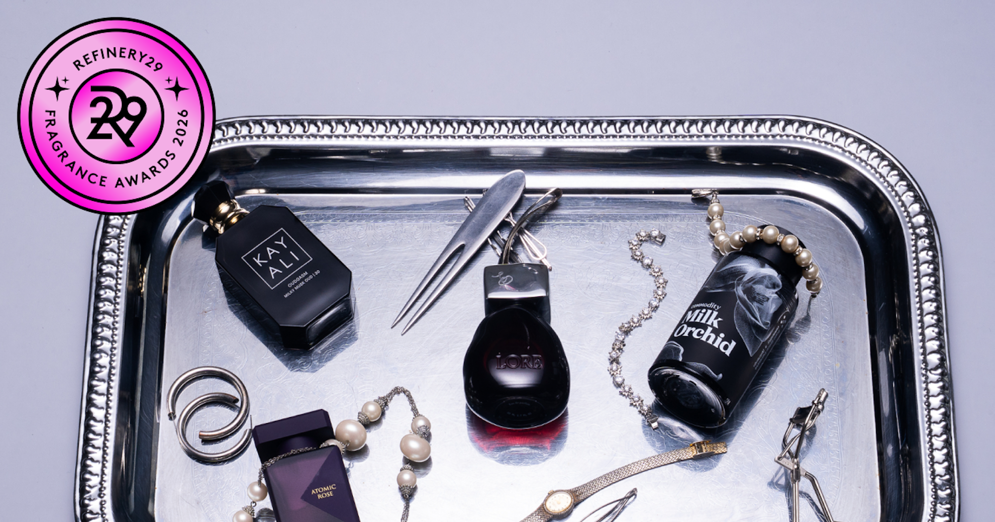 Several glass perfume bottles arranged on a light surface