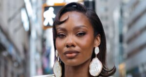 Fashion week attendees showcasing polished hairstyles on a city sidewalk