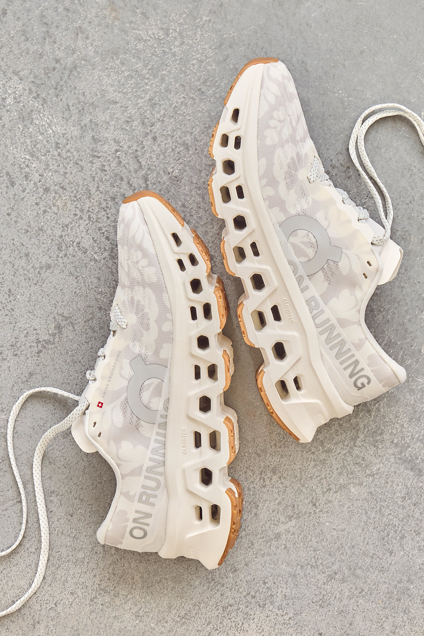 Close-up of floral-patterned athletic running shoes on a neutral surface