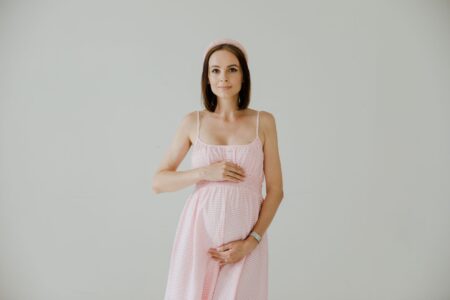 Regency Dressing Is Back, and Here’s How to Wear It Woman in a soft empire-waist dress with minimal styling against a neutral background