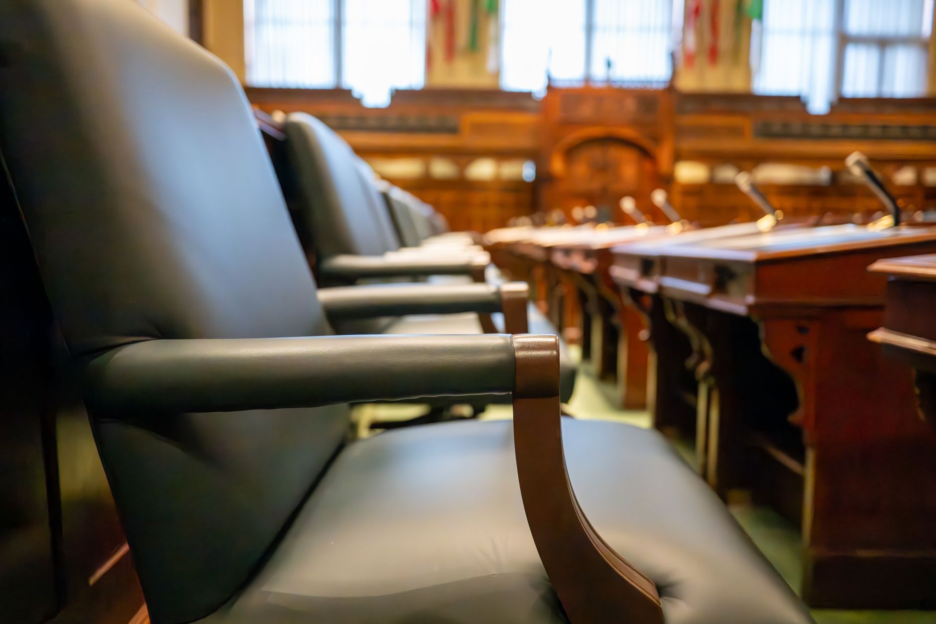 Empty courtroom with wooden benches and overhead lighting