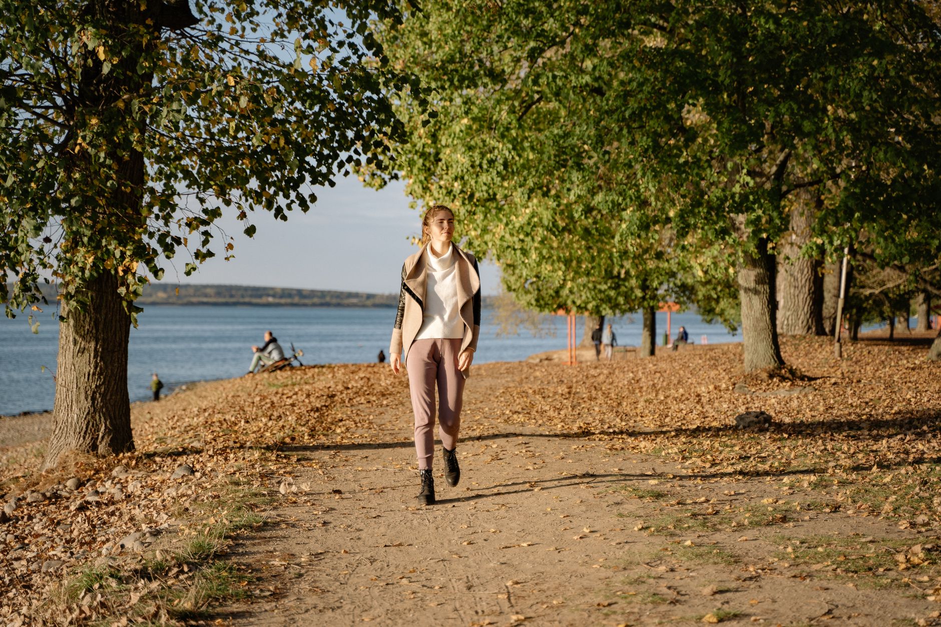 Close-up of a rich brown suede jacket draped over a chair in autumn light