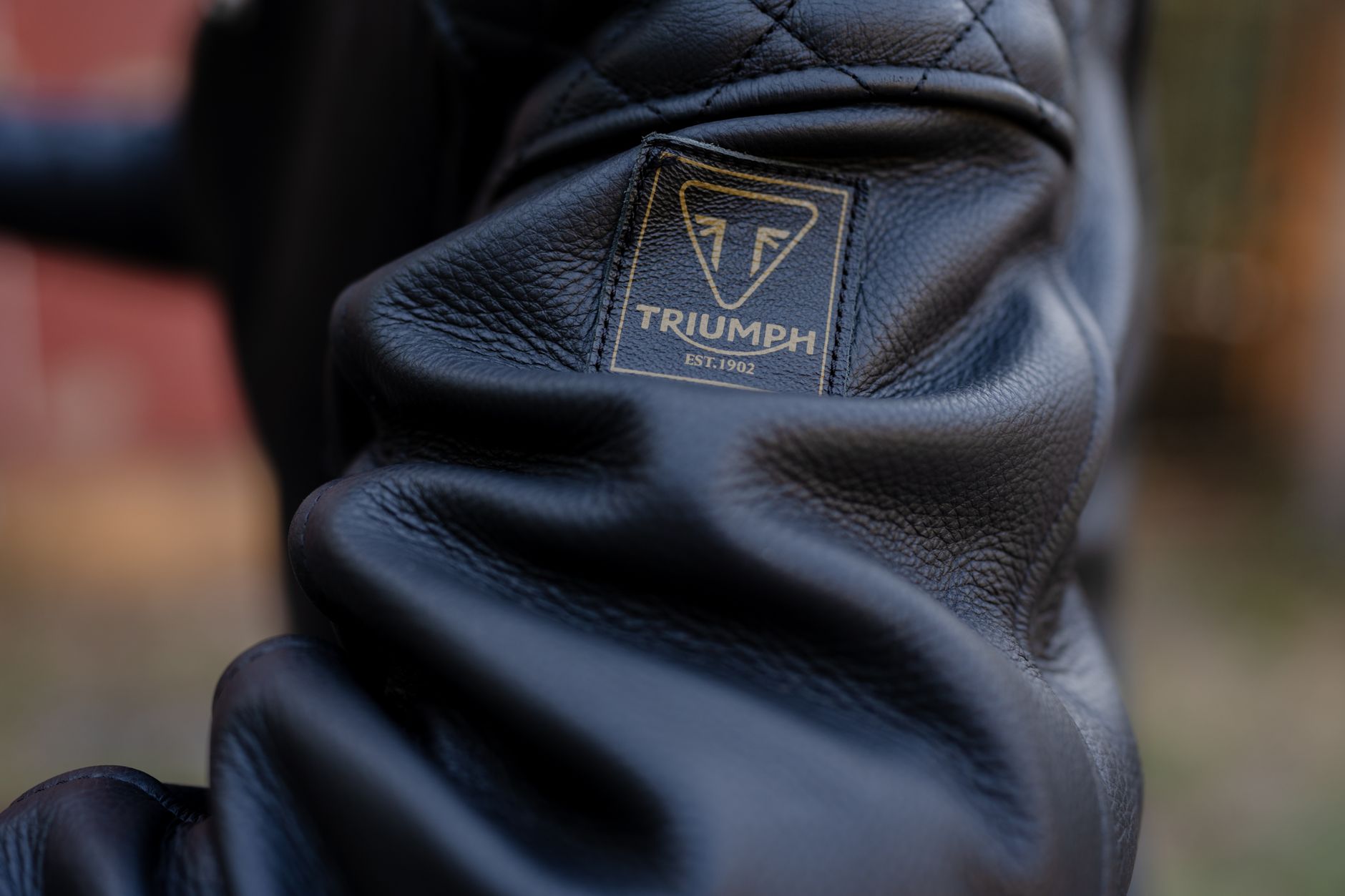 Close-up of worn brown leather jacket texture in soft light