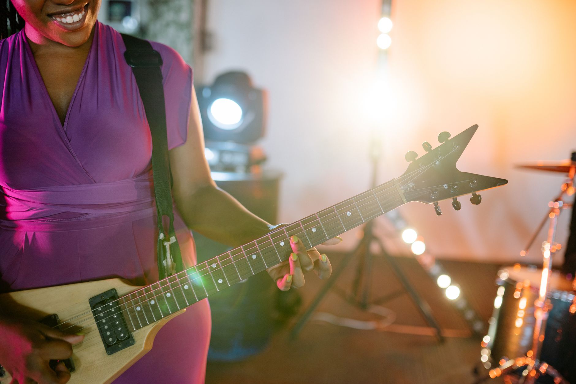 A young Black woman in a creative performance space
