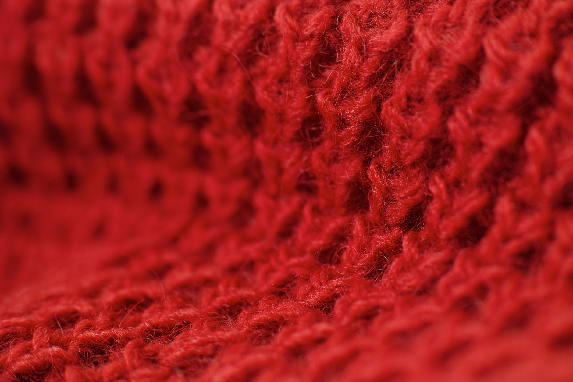 A rich-toned autumn knit sweater folded on a clean surface