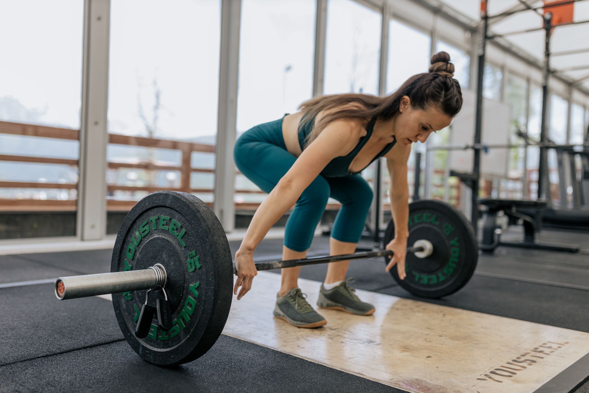 Close-up of weight plates loaded on a barbell during a strength training session